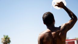 PHOENIX, ARIZONA - JULY 16: A person cools off amid searing heat that was forecast to reach 115 degrees Fahrenheit on July 16, 2023 in Phoenix, Arizona. A heat dome over Texas that has expanded to California, Nevada and Arizona is subjecting millions of Americans to excessive heat warnings, according to the National Weather Service. (Photo by Brandon Bell/Getty Images)