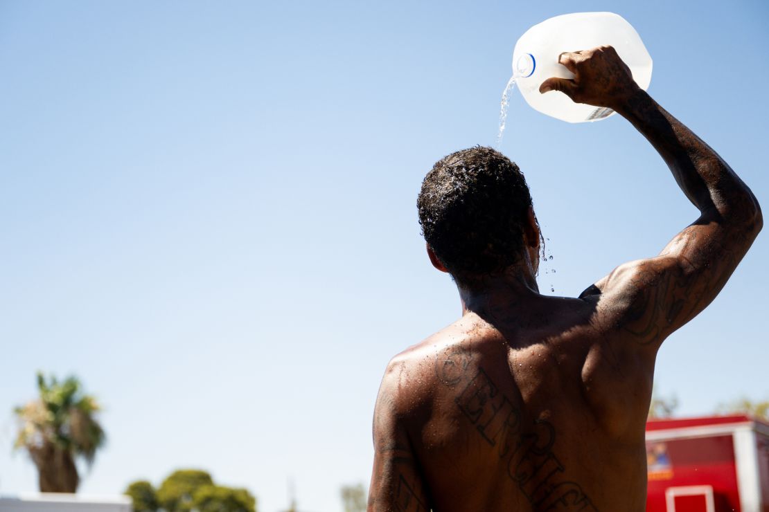 A person cools off amid searing heat on July 16, 2023, in Phoenix. A heat dome over Texas that has expanded to California, Nevada and Arizona is subjecting millions of Americans to excessive heat. warnings, according to the National Weather Service. 