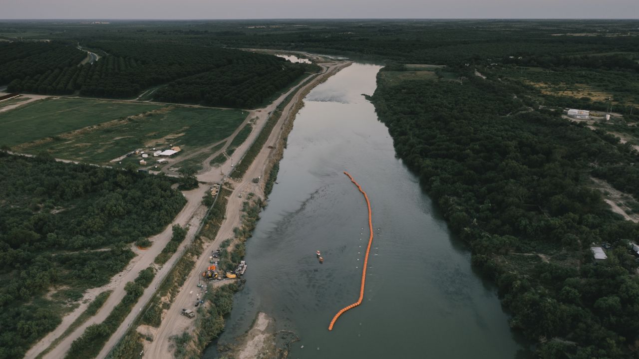 A string of buoys used as a border barrier on the Rio Grande River in Eagle Pass, Texas, US, on Thursday, July 13, 2023. Texas started deploying a new floating barrier on the Rio Grande as a way to deter migrant crossings at the US-Mexico border. Photographer: Jordan Vonderhaar/Bloomberg via Getty Images