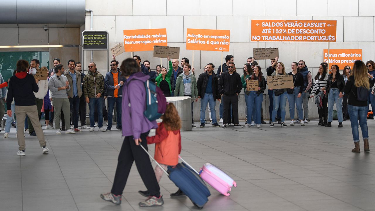 Travelers make their way to the departures area past cabin crew on a picket line, during pay-related strike action by EasyJet Plc, outside Lisbon Airport in Lisbon, Portugal, on Saturday, April 1, 2023. EasyJet cabin crew in Portugal have called a strike after an impasse in negotiations with the company. Photographer: Zed Jameson/Bloomberg via Getty Images