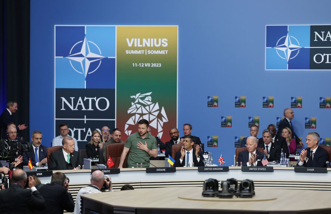 Ukrainian President Volodymyr Zelenskyy (2nd L) applauded by Turkish President Recep Tayyip Erdogan (L), Britain's Prime Minister Rishi Sunak (3rd R) and US President Joe Biden (2nd R) as he is introduced at a meeting of the NATO-Ukraine Council during the NATO Summit in Vilnius on July 12, 2023. 