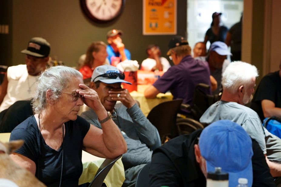 People sit in a crowded room at Phoenix's Justa Center, one of the area's many cooling centers, on July 16.