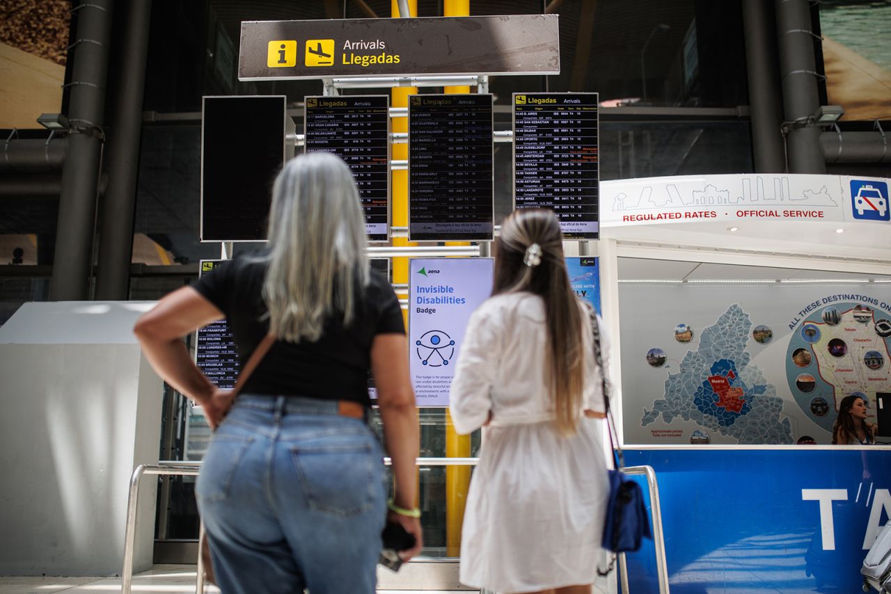 MADRID, SPAIN - JUNE 21: Two passengers look at an arrivals board at Adolfo Suarez-Madrid Barajas Airport, on 21 June, 2023 in Madrid, Spain. Air Europa has canceled ten flights of its schedule for today due to the strike that its pilots are supporting from Monday, June 19 and until Sunday, July 2 in all the bases and work centers of the company in the State. The Spanish Airline Pilots Union (Sepla) is demanding an agreement to put an end to eleven years of loss of purchasing power "without having to give up labor rights included in the IV Collective Bargaining Agreement". This is the third strike, after the union called eight days of strike action between May 22 and June 2, during which 114 domestic and European flights were cancelled. During this third day of protests, the airline has canceled 135 flights. (Photo By Alejandro Martinez Velez/Europa Press via Getty Images)