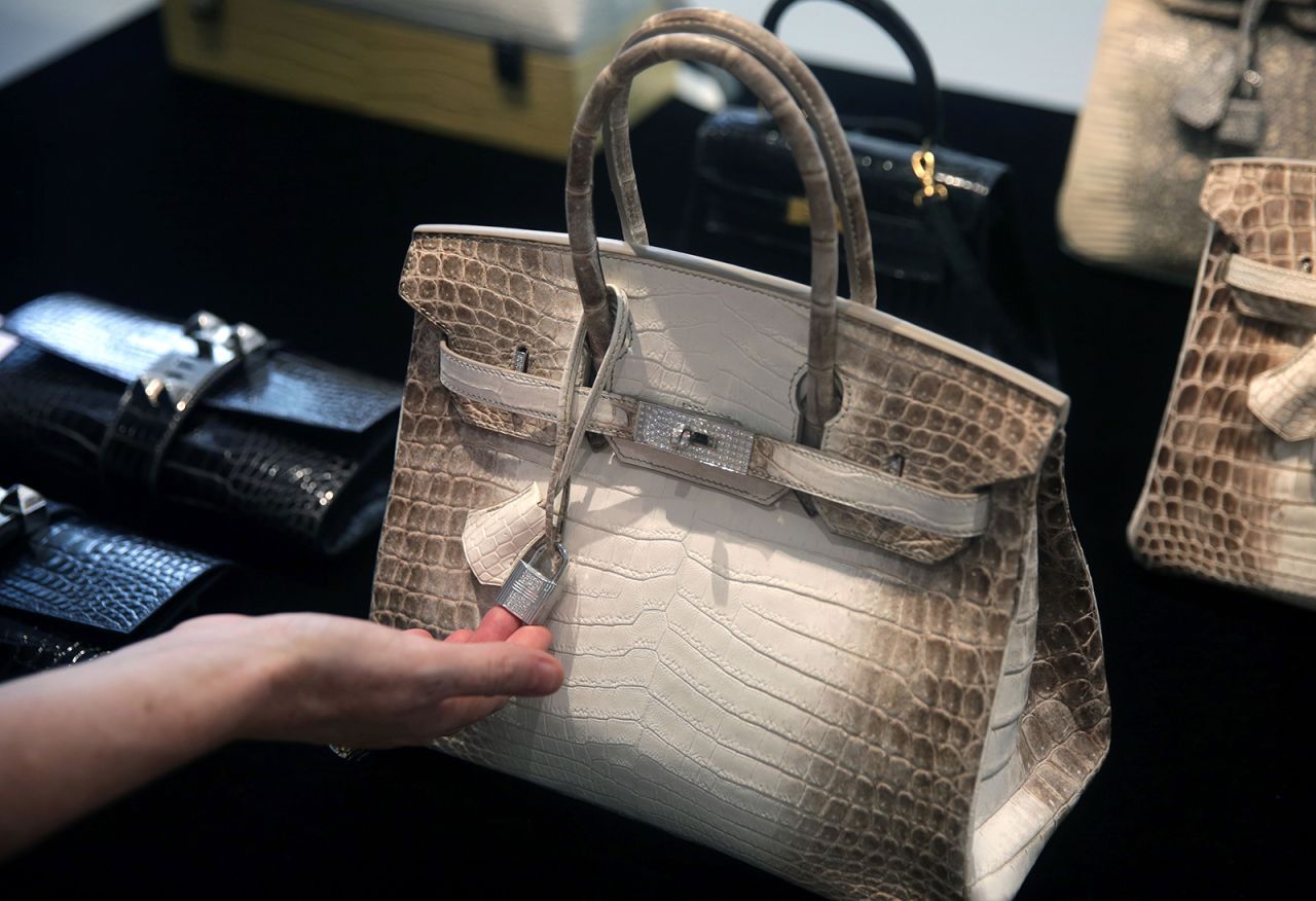 A Matte White Himalaya Niloticus Crocodile Diamond Birkin with 18K gold and diamond hardware -- one of the most valuable handbags in the world -- sits on display during a preview at Christies in Hong Kong on May 4, 2016. / AFP / ISAAC LAWRENCE        (Photo credit should read ISAAC LAWRENCE/AFP via Getty Images)