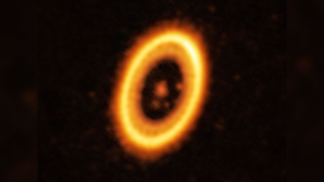This image, taken with the Atacama Large Millimeter/submillimeter Array (ALMA), in which ESO is a partner, shows the young planetary system PDS 70, located nearly 400 light-years away from Earth. The system features a star at its centre, around which the planet PDS 70 b is orbiting. On the same orbit as PDS 70b, astronomers have detected a cloud of debris that could be the building blocks of a new planet or the remnants of one already formed. The ring-like structure that dominates the image is a circumstellar disc of material, out of which planets are forming. There is in fact another planet in this system: PDS 70c, seen at 3 o'clock right next to the inner rim of the disc.