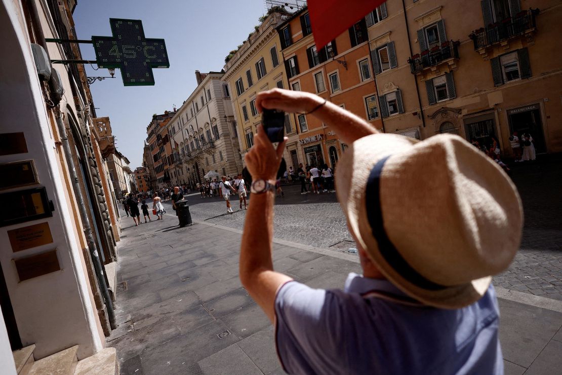 A man takes a picture of a sign that shows the temperature degree, near the Spanish Steps, during a heat wave across Italy as temperatures are expected to rise further in the coming days, in Rome, Italy July 17, 2023. REUTERS/Guglielmo Mangiapane