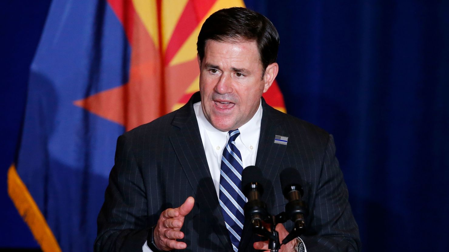 In this Tuesday, August 2020 photo, Republican Arizona Gov. Doug Ducey speaks prior to Vice President Mike Pence speaking at the "Latter-Day Saints for Trump" Coalition launch event in Mesa, Arizona.