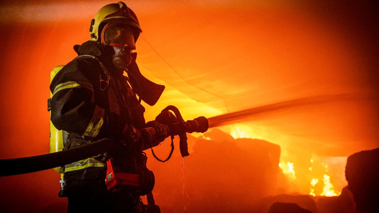 A firefighter works at a site of storage facilities hit during Russian missile and drone strikes, in Odesa, in southern Ukraine, on Wednesday.