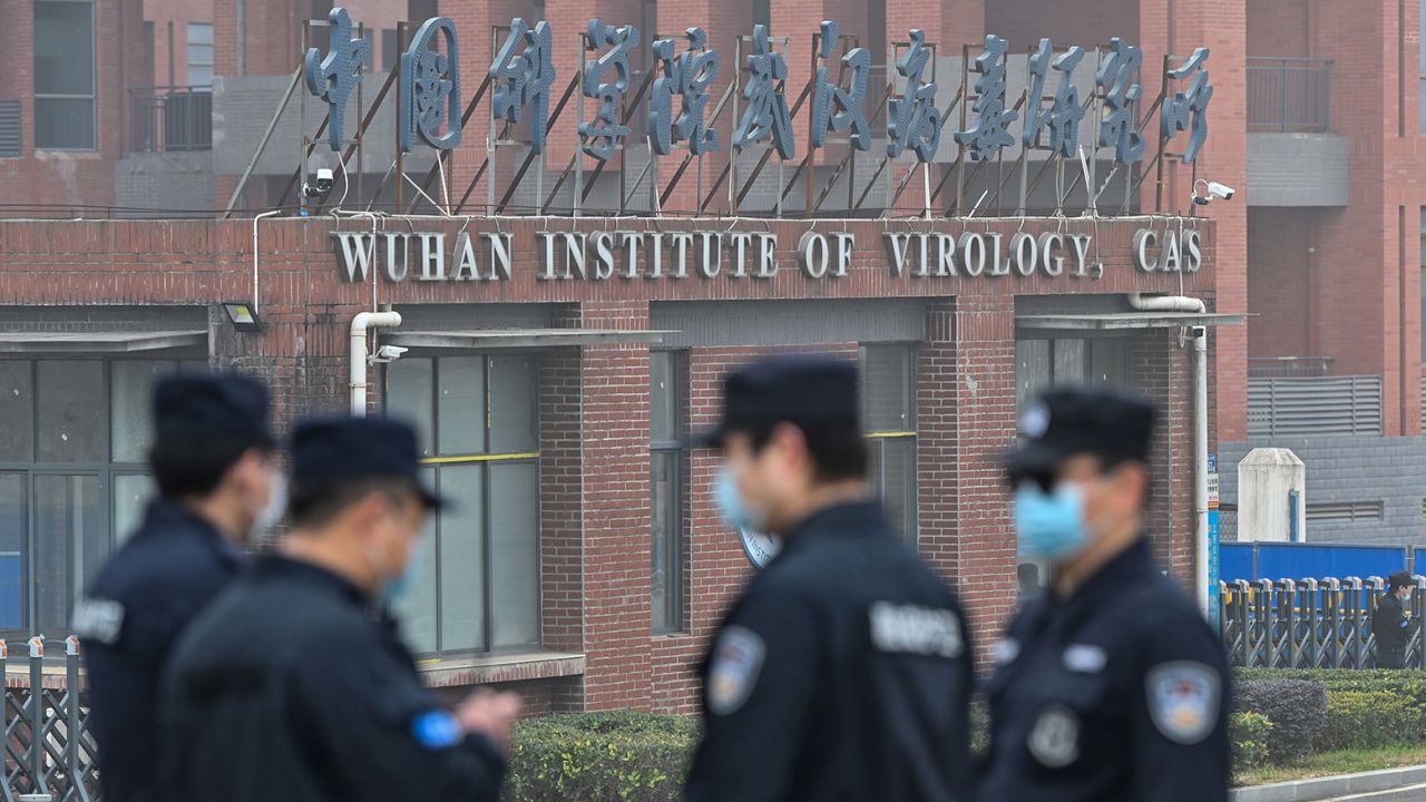Security personnel stand guard outside the Wuhan Institute of Virology in Wuhan in February 3, 2021. 
