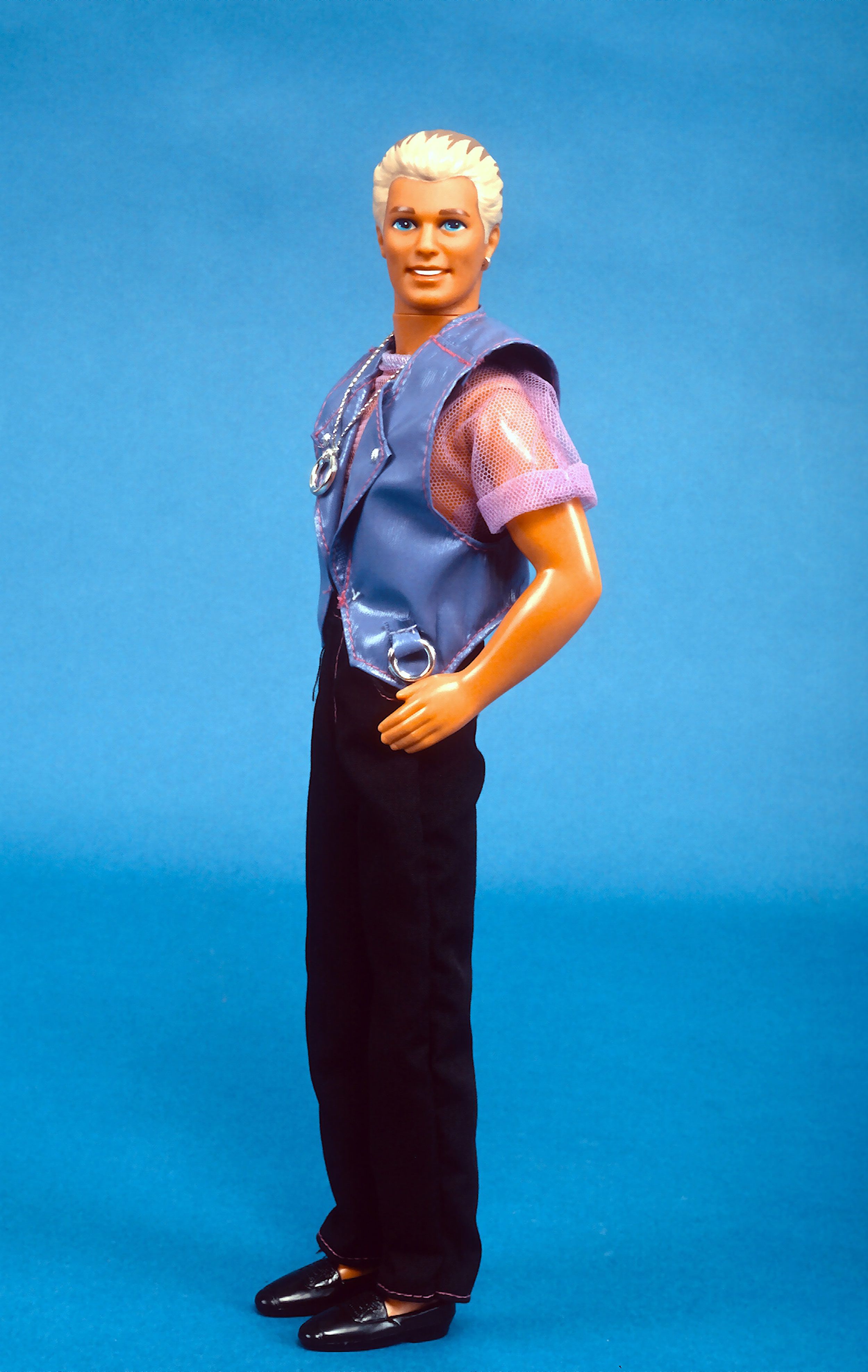 NEW YORK, NY - AUGUST 5: Earring Magic Ken, introduced by Mattel as a companion to its Earring Magic Barbie figure, is photographed August 5, 1993 in New York City. This stylish Ken doll features an updated look which includes blonde highlights in his traditionally brown hair, a purple shirt, lavender vest, a necklace with a circular charm and an earring in its left ear. (Photo by Yvonne Hemsey/Getty Images)