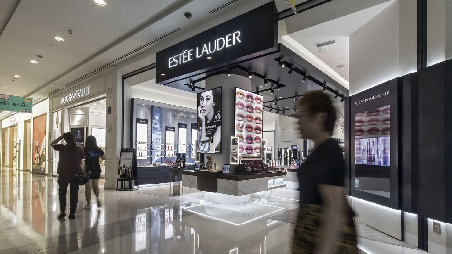Shoppers walk past an Estee Lauder Companies Inc. store in the Raffles City shopping mall in Shanghai, China, on Wednesday, May 31, 2017. 