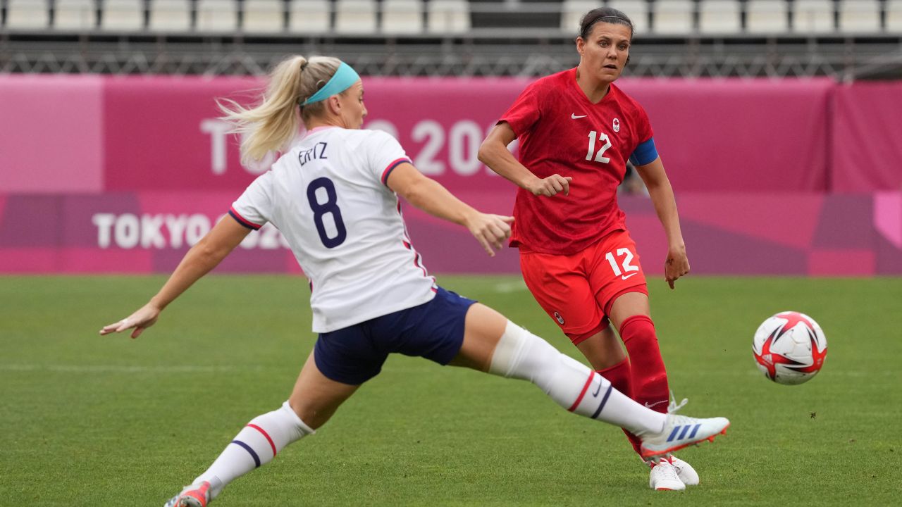 Sinclair kicks the ball past USWNT midfielder Julie Ertz during the women's semifinal at the 2020 Tokyo Olympic Games.