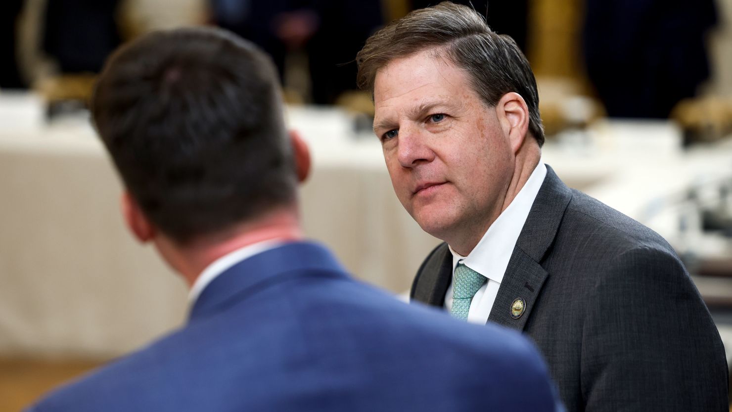 New Hampshire Governor Chris Sununu  waits for the start of a meeting between U.S. President Joe Biden and governors visiting from states around the country in the East Room of the White House on February 10, 2023 in Washington, DC.