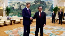 U.S. Special Presidential Envoy for Climate John Kerry, left, and Chinese Premier Li Qiang shake hands before a meeting at the Great Hall of the People in Beijing Tuesday, July 18, 2023. 