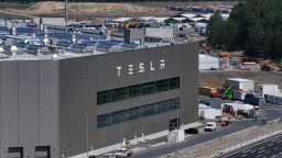 GRUENHEIDE, GERMANY - JULY 17: In this aerial view the Tesla logo hangs on the facade of a building at the Tesla factory on July 17, 2023 near Gruenheide, Germany. Tesla will reportedly present its plans tomorrow to expand production at the factory, from thee current level of approximately 250,000 cars per year to one million. The plan calls for the construction of a new assembly hall that will be the size of 60 soccer fields, which is likely to draw opposition from local communities.  (Photo by Sean Gallup/Getty Images)