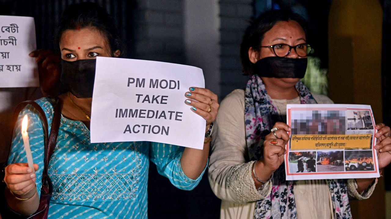 Protesters hold placards during a demonstration over sexual violence against women in Manipur, in Guwahati on Thursday. CNN has blurred a portion of this photograph that showed graphic imagery.