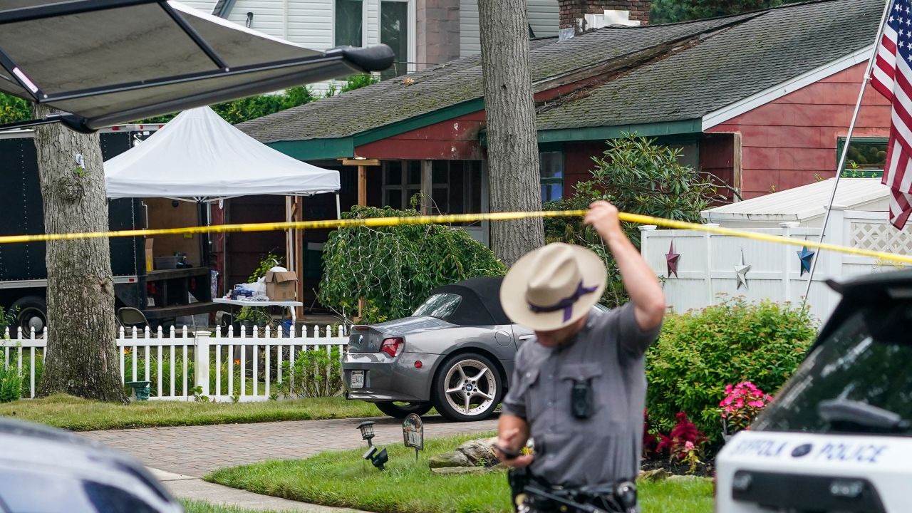Authorities work outside as they search the home of suspect Rex Heuermann, Wednesday, July 19, 2023, in New York. Police carted more boxes of potential evidence Tuesday out of the Long Island home of Heuermann, who has been charged with killing at least three women and leaving their remains alongside a beach highway. (AP Photo/John Minchillo)