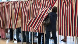 A voter enters a booth to fill out their ballot at Parker-Varney Elementary School on November 08, 2022 in Manchester, New Hampshire.