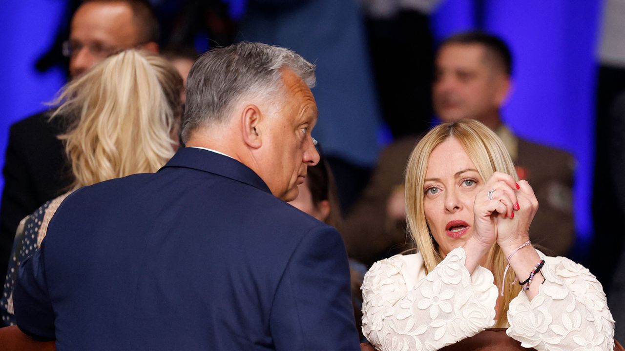 Italy's Prime Minister Giorgia Meloni speaks with her Hungarian counterpart Viktor Orban at the NATO summit in Vilnius on July 12, 2023.