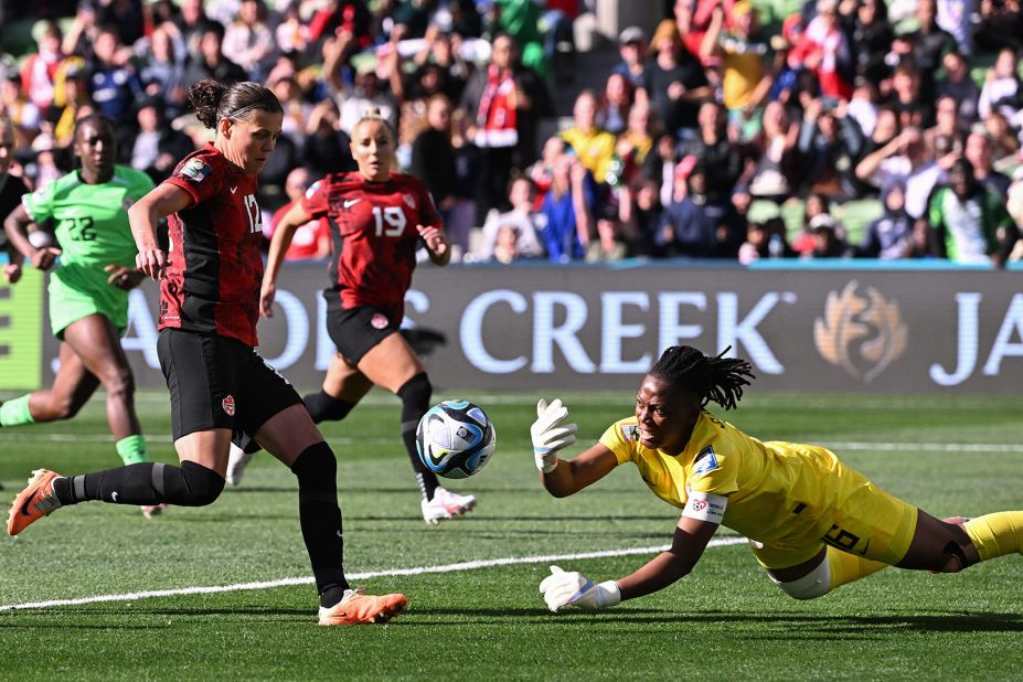 Nigerian goalkeeper Chiamaka Nnadozie clears the ball after saving a penalty by Canada's Christine Sinclair.