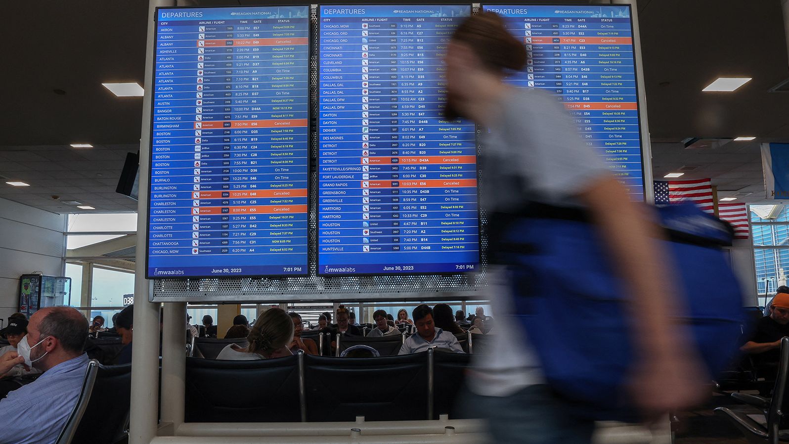Travelers check the status of their flights ahead of the July 4th holiday weekend at Ronald Reagan Washington National Airport in Arlington, Virginia, U.S., June 30, 2023. REUTERS/Evelyn Hockstein