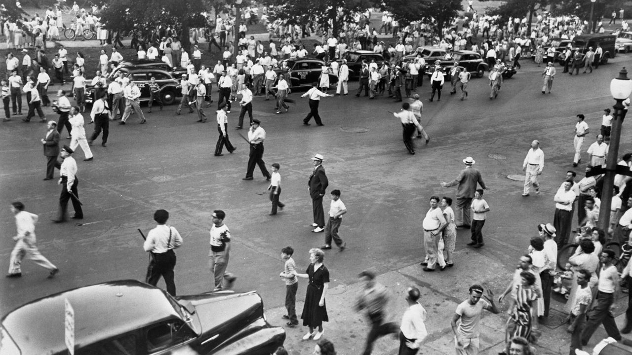 Police armed with nightsticks disperse part of a crowd of 5,000 people during a riot in St. Louis in 1949. 13 people were injured. Several Black people were beaten and stoned. The fighting broke out as the result of a directive which permitted Black people to use swimming pools in public parks along with White people. The mayor later rescinded the order.