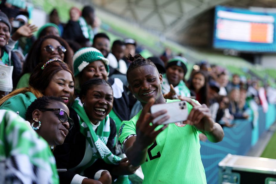 Nigeria's Uchenna Kanu takes a selfie with fans after the Canada match.