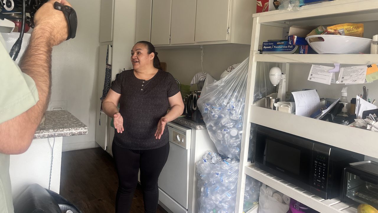 Yolanda Cendejas, a janitor laid off from Paramount Studios, shows CNN the bags of plastic bottles she's collecting for cash on June 28.
