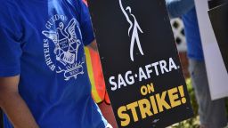 A SAG-AFTRA strike sign is displayed as Teamsters Union members join members of the Writers Guild of America and the Screen Actors Guild on strike outside Amazon Studios in Culver City, California, on July 19, 2023. Tens of thousands of Hollywood actors went on strike at midnight July 13, 2023, effectively bringing the giant movie and television business to a halt as they join writers in the first industry-wide walkout for 63 years.