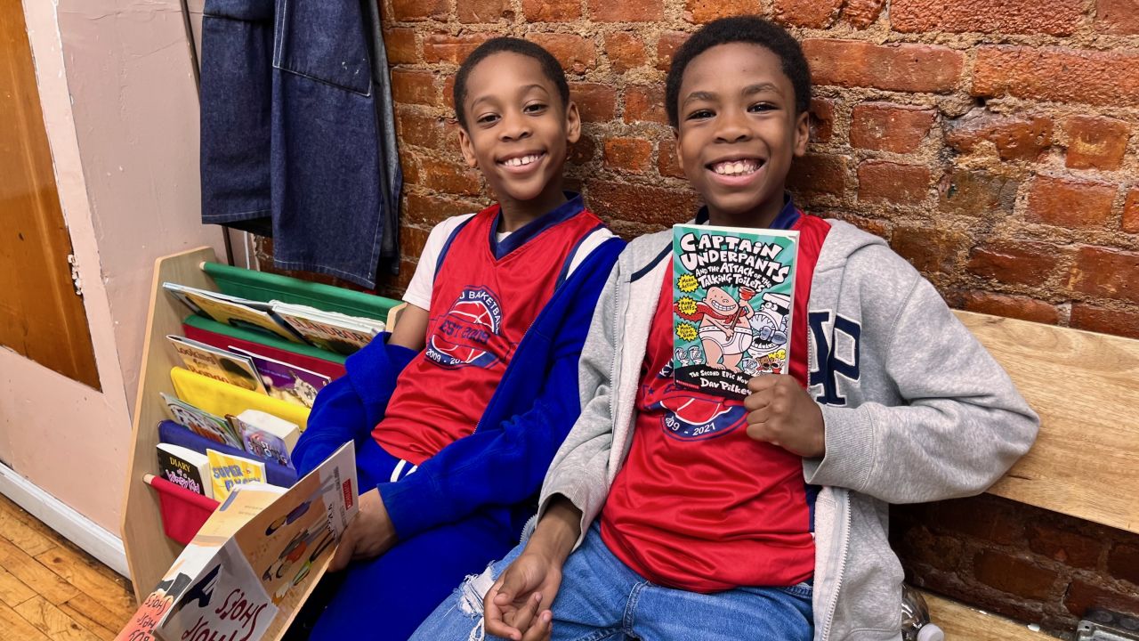 Brothers Chase, left, and Chance, right, enjoy reading each time they visit their local barbershop.