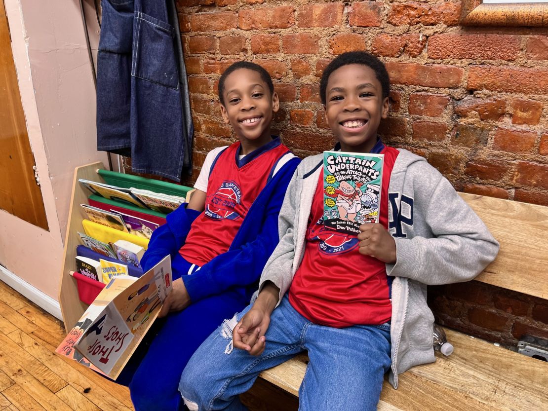 Brothers Chase, left, and Chance, right, enjoy reading each time they visit their local barbershop.