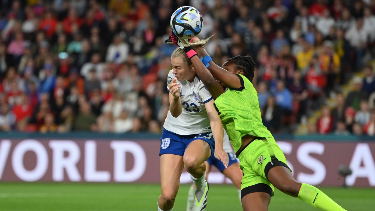 Alessia Russo of England clashes with Kerly Theus of Haiti.