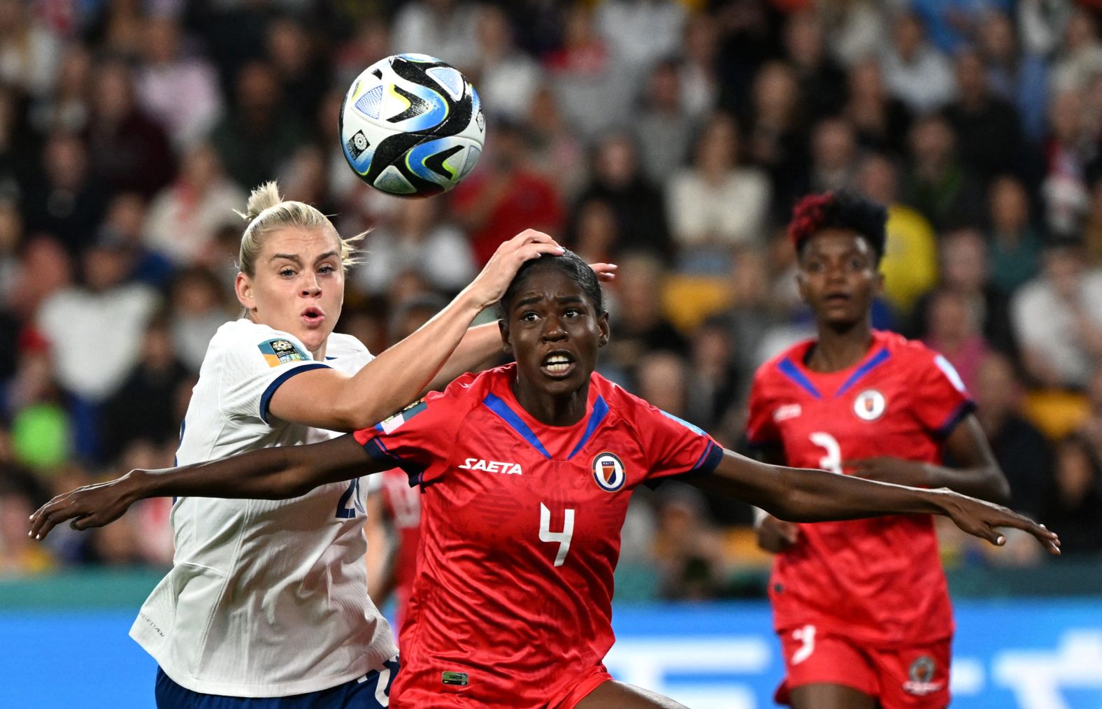 England's Alessia Russo and Haiti's Tabita Joseph fight for the ball during the two sides' opening game on July 22. England's Lionesses, the reigning European champions, earned a scrappy 1-0 victory over the tournament debutants.