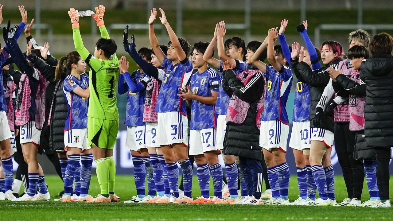 Japan's players line up and acknowledge the crowd following their 5-0 win.