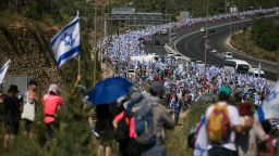 Thousands of Israelis march to Jerusalem holding the Israeli flag to protest the government's overhaul plan on July 22, 2023 in Mevaseret Zion, Israel. Monday sees the second and third parliamentary votes on the judicial reform bill that has been the cause of protests across the country. 