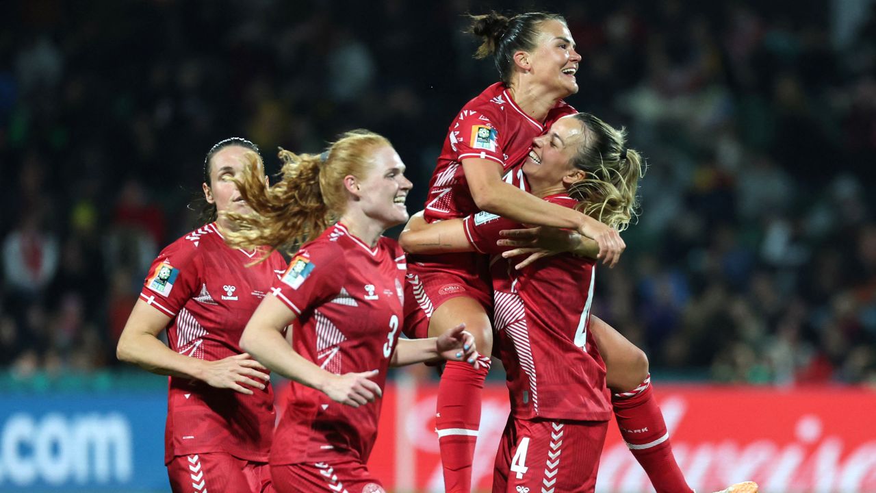 Denmark players celebrate scoring against China in its opening game. 