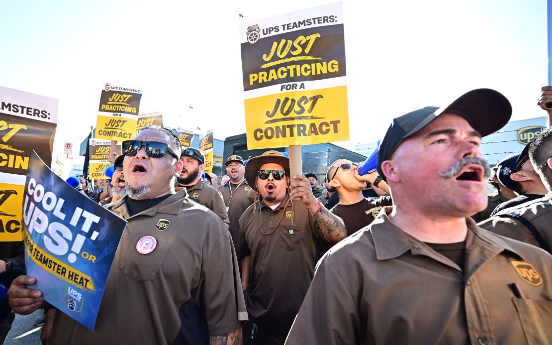 UPS workers hold placards at a rally held by the Teamsters Union on July 19, 2023 in Los Angeles, California.