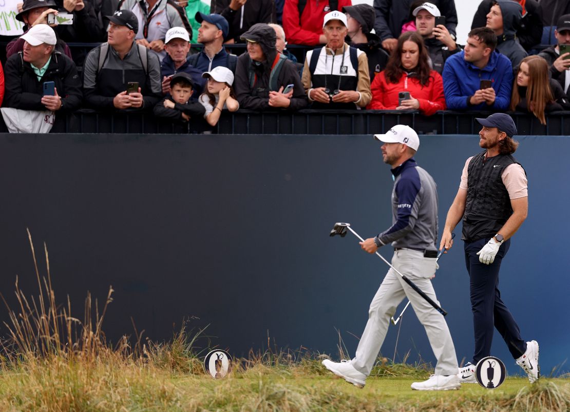 HOYLAKE, ENGLAND - JULY 22: Brian Harman of the United States and Tommy Fleetwood of England looks on after teeing off on the 9th hole on Day Three of The 151st Open at Royal Liverpool Golf Club on July 22, 2023 in Hoylake, England. (Photo by Gregory Shamus/Getty Images)