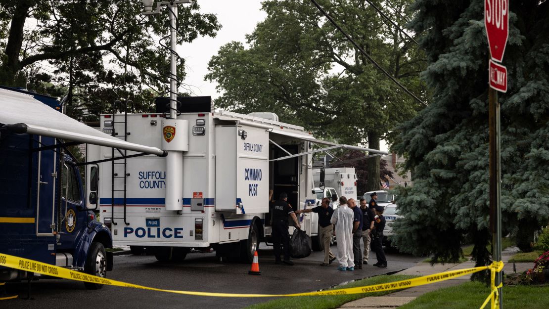 Crime laboratory officers are seen outside Rex Heuermann's home in Massapequa Park on July 18, 2023. 