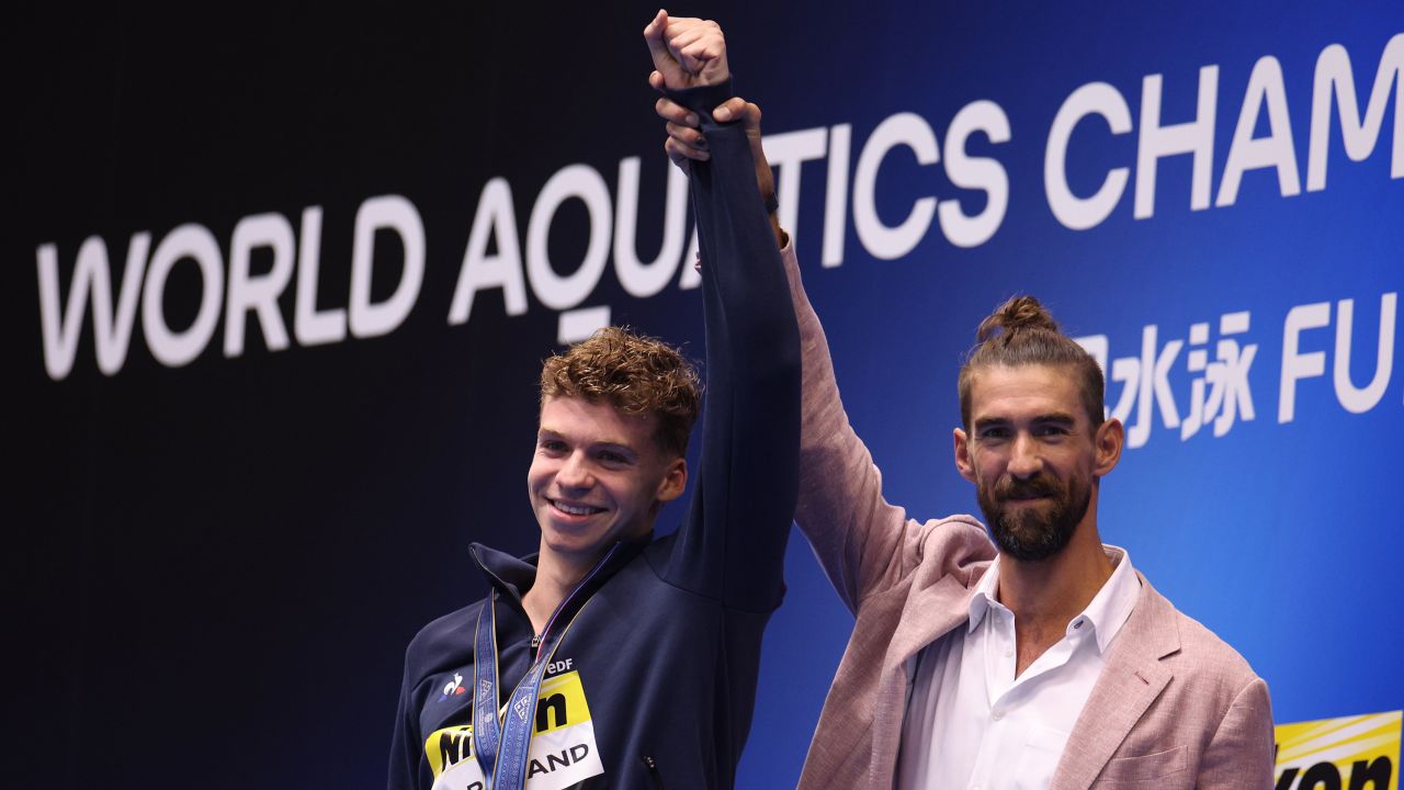 Gold medallist Leon Marchand of Team France is congratulated by Michael Phelps during the medal ceremony for the Men's 400m Individual Medley Final on day one of the Fukuoka 2023 World Aquatics Championships at Marine Messe Fukuoka Hall A on July 23, 2023 in Fukuoka, Japan.