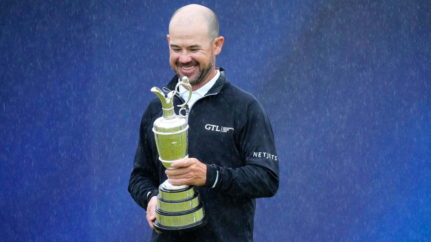 United States' Brian Harman poses for the media as he holds the Claret Jug trophy for winning the British Open Golf Championships at the Royal Liverpool Golf Club in Hoylake, England, Sunday, July 23, 2023.