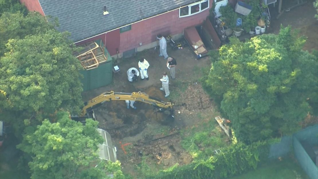 Investigators search the backyard of Rex Heuermann's home on Sunday. 