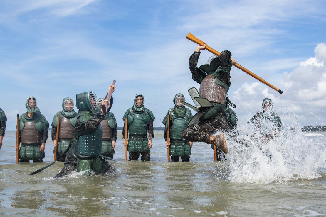 Armed police officers and soldiers strengthen their training in seawater in Fangchenggang City, Guangxi Province, China, July 24, 2023. (Photo by Costfoto/NurPhoto via Getty Images)