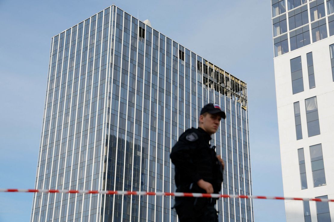 A member of the security services stands guard next to a damaged building in the Russian capital on Monday.