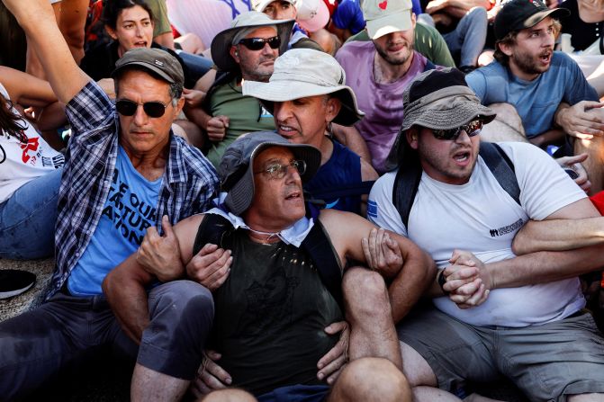 Protesters link arms as they attempt to block a road leading to the Knesset on July 24.