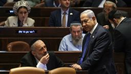 Israel's Prime Minister Benjamin Netanyahu (R) speaks with Aryeh Deri (L), chairman of the ultra-Orthodox party Shas, during a parliament session in Jerusalem on July 24, 2023, amid a months-long wave of protests against the government's planned judicial overhaul. Israeli lawmakers on July 24 prepared for a final vote on a major component of the hard-right government's controversial judicial reforms even as US President Joe Biden called for postponing the "divisive" bill that has triggered mass protests. (Photo by RONALDO SCHEMIDT / AFP) (Photo by RONALDO SCHEMIDT/AFP via Getty Images)