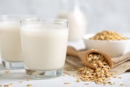 Oat milk. Healthy vegan organic drink with flakes