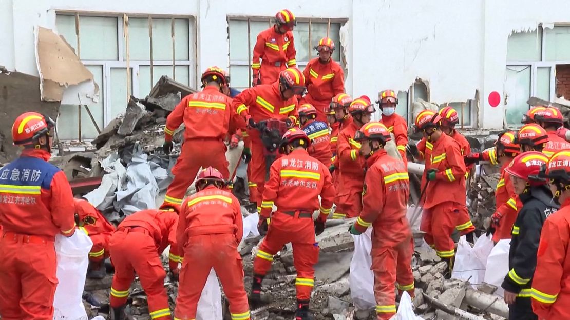 Rescue workers respond after the collapse of a roof on a middle school gymnasium in China's northeastern city of Qiqihar.