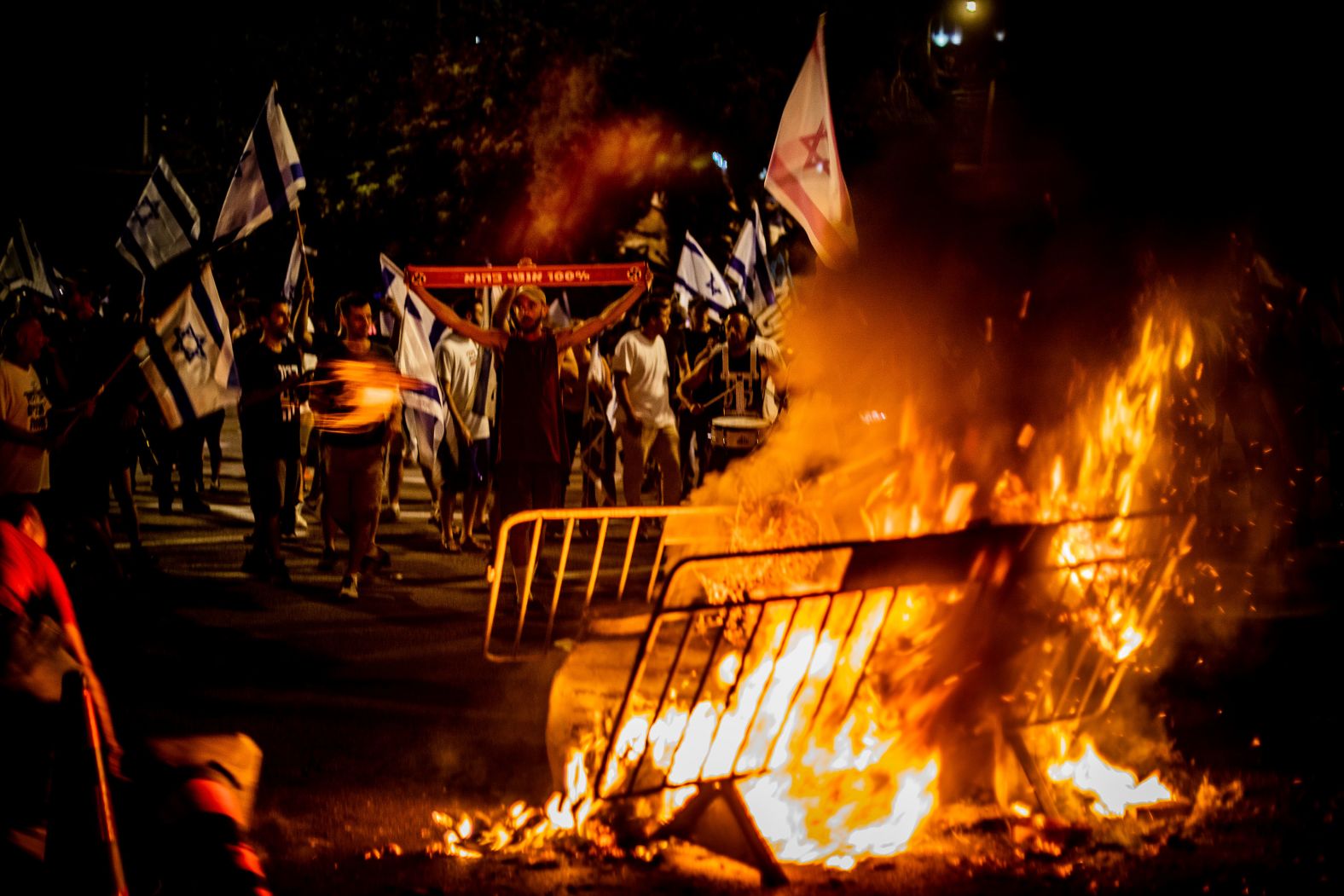 People protest next to a bonfire in Tel Aviv on Thursday, July 20.