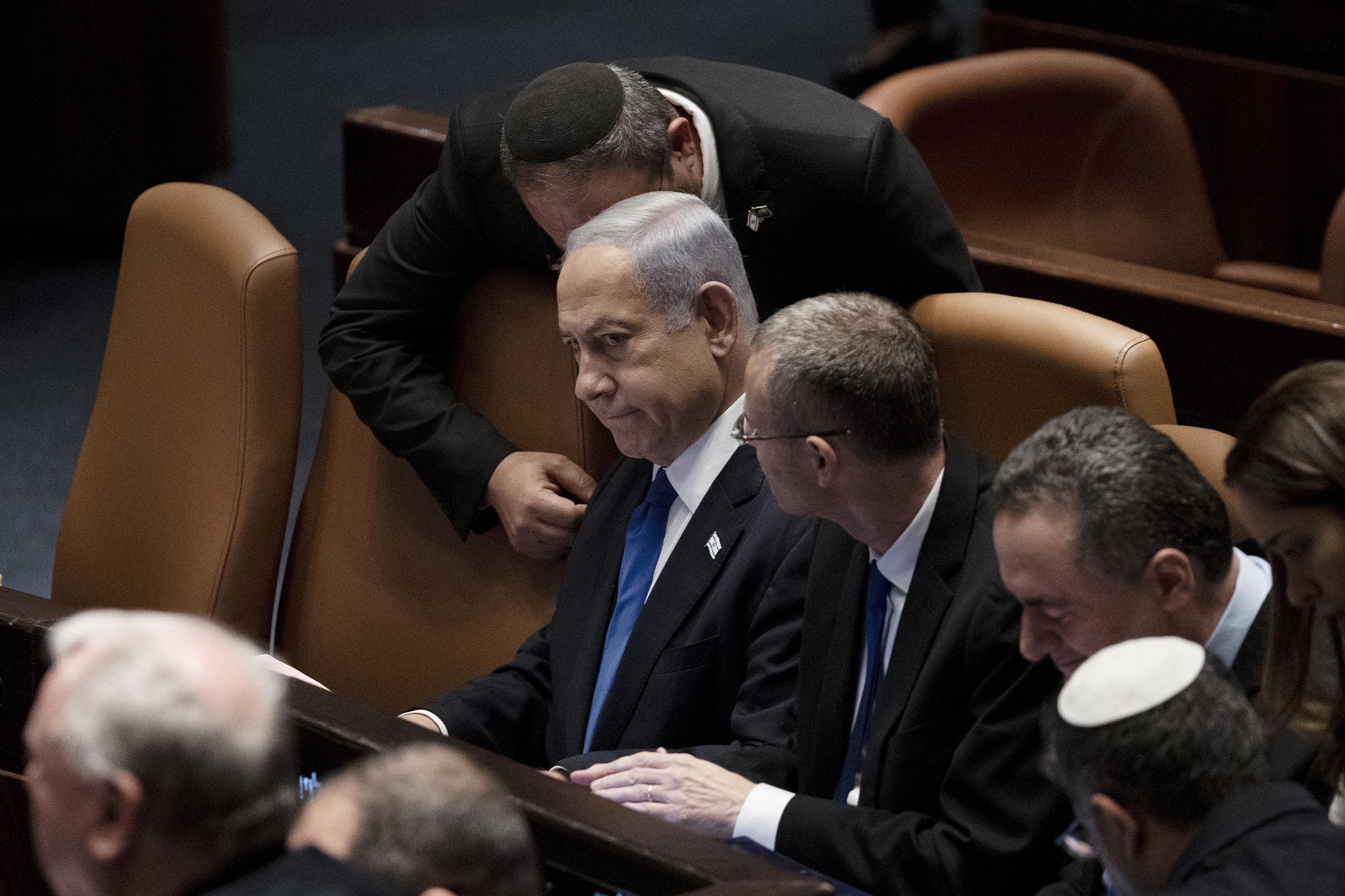 Netanyahu surrounded by lawmakers at a session of the Knesset in July 2023.